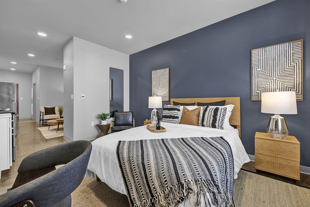 a bedroom with blue walls and a white bed