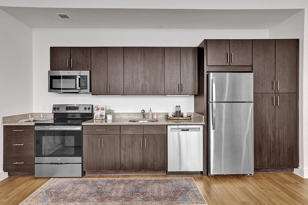 a kitchen with stainless steel appliances and wooden cabinets