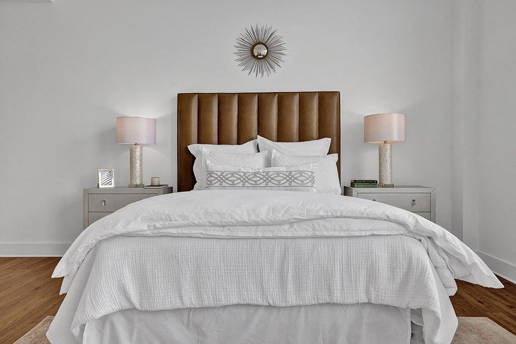 a bedroom with a bed and two lamps