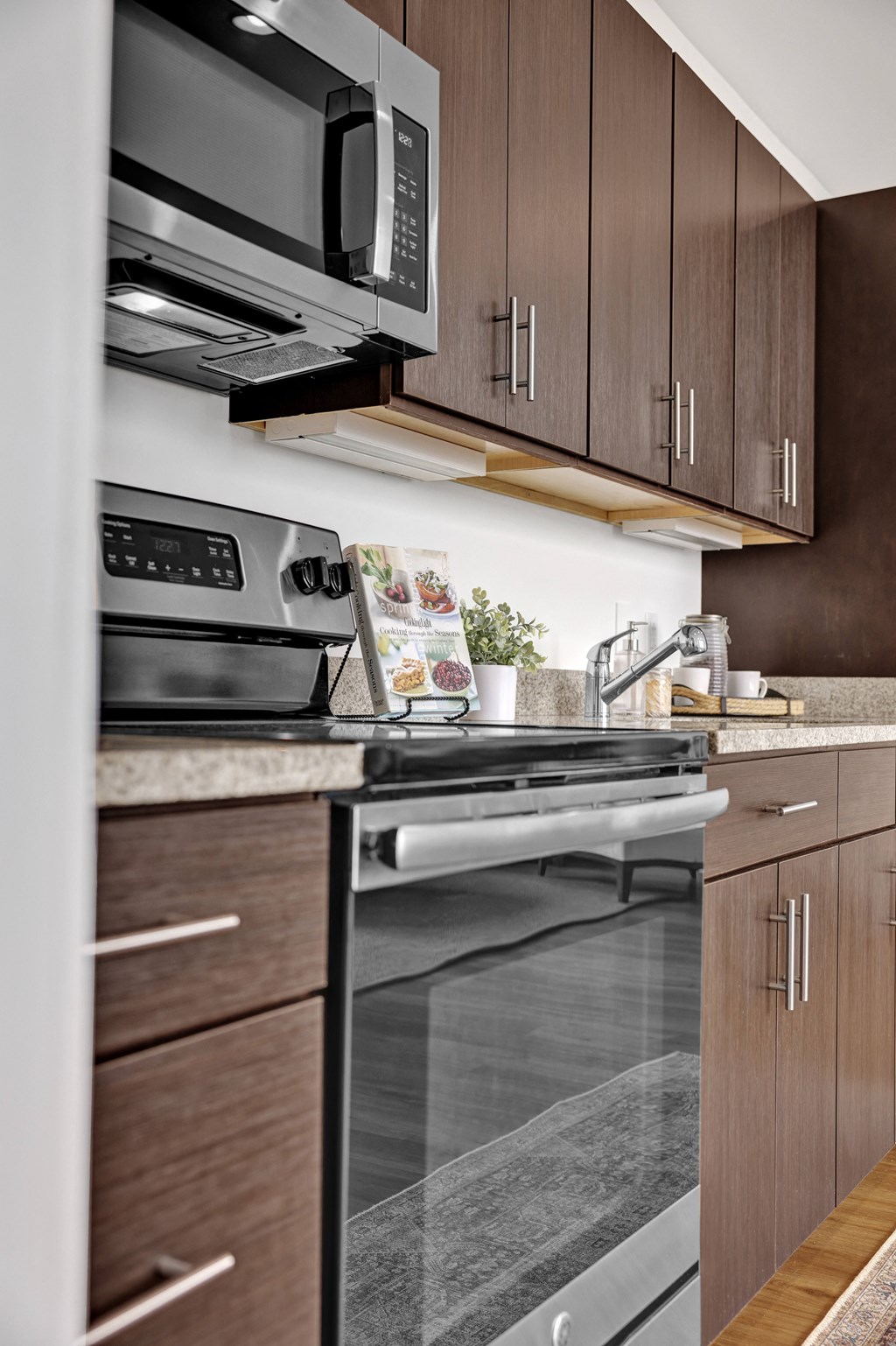 a kitchen with wooden cabinets and a stove and a microwave