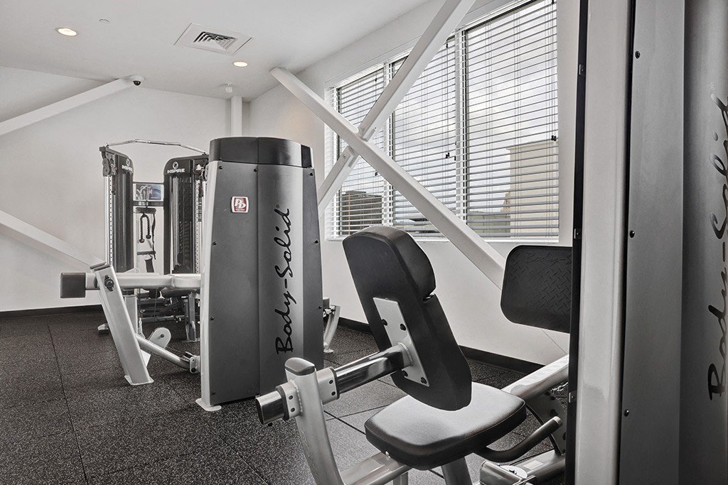 a gym with exercise equipment and a window