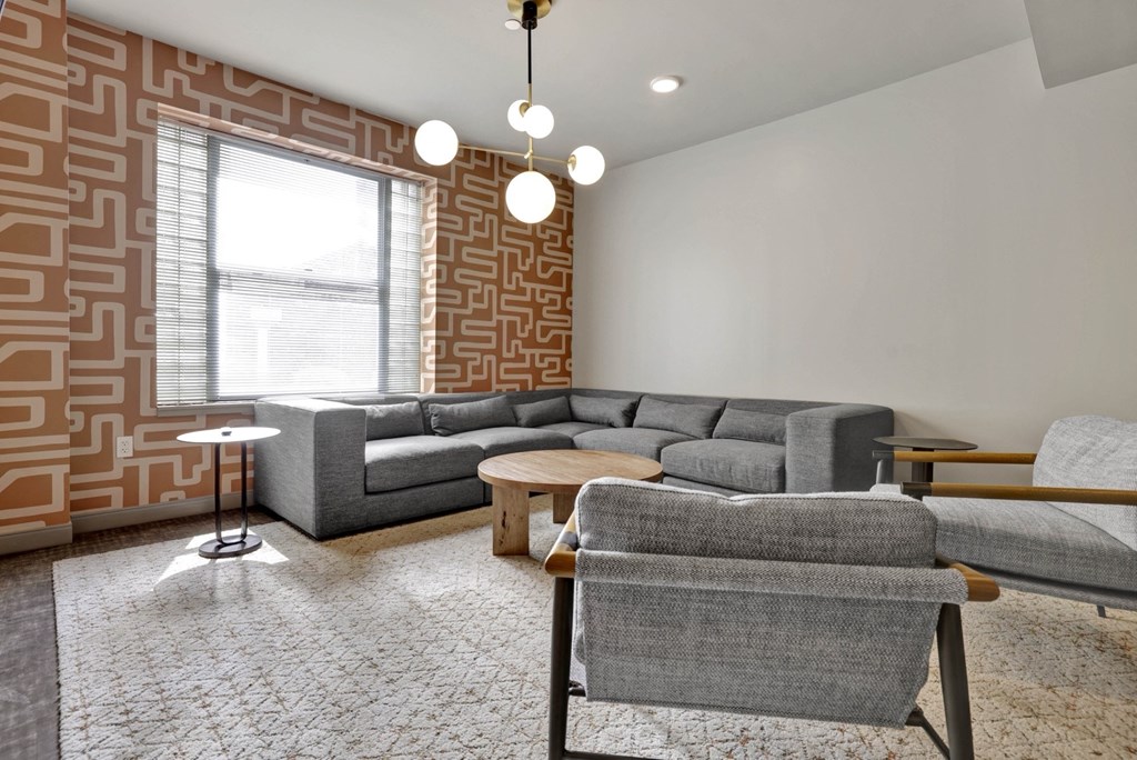 a living room with couches and chairs and a window