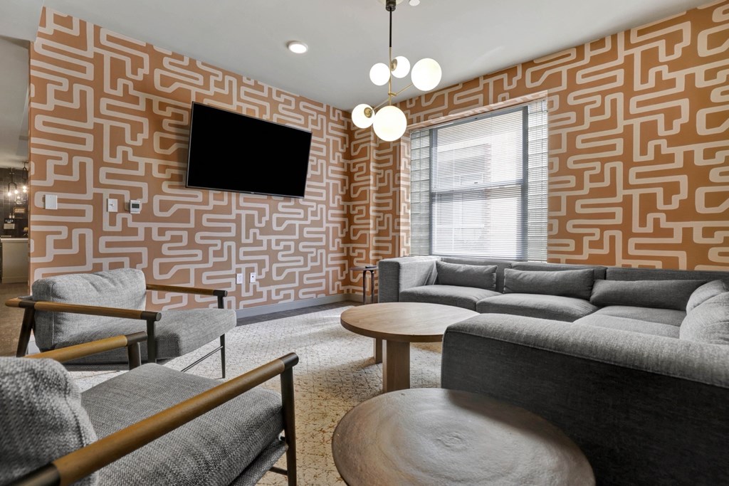 a living room with couches and chairs and a television