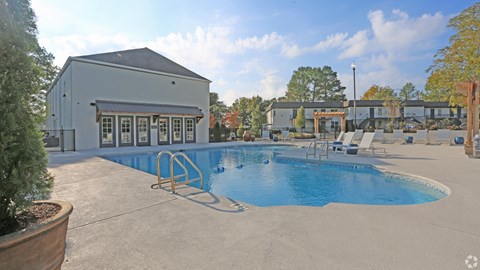 Sparkling pool with expansive sundeck and chaise lounges at Avia Apartments in Vestavia Hills, AL