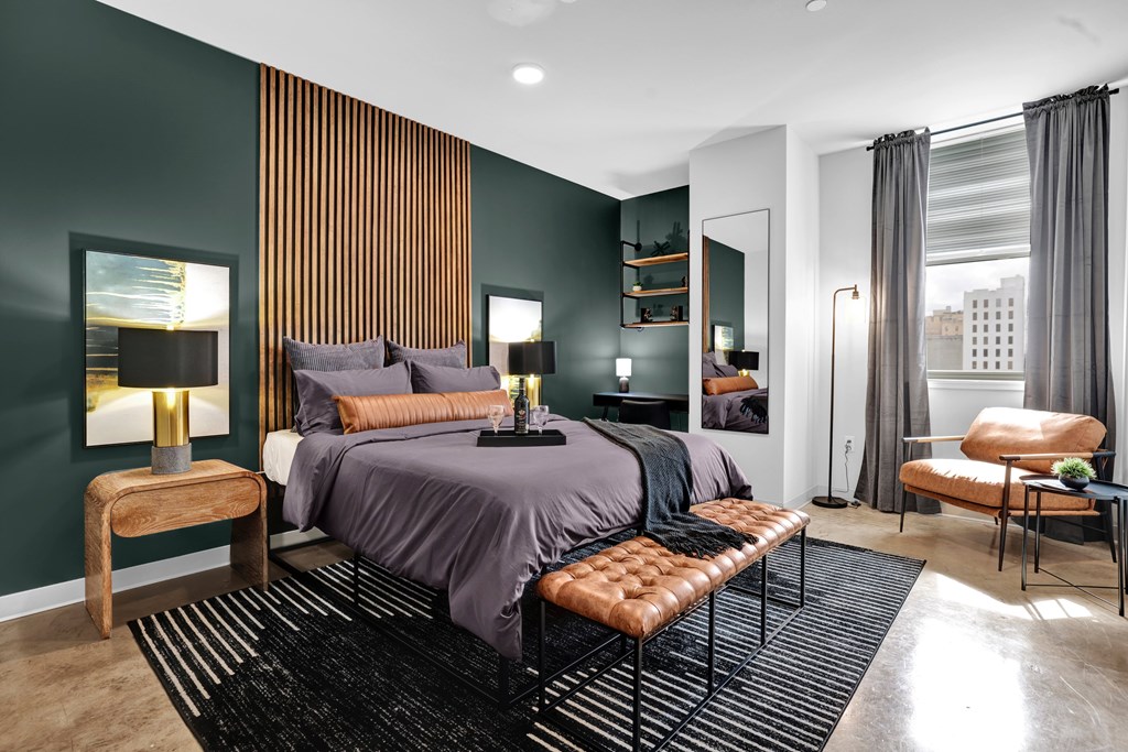 A modern bedroom with a large bed and a chair.