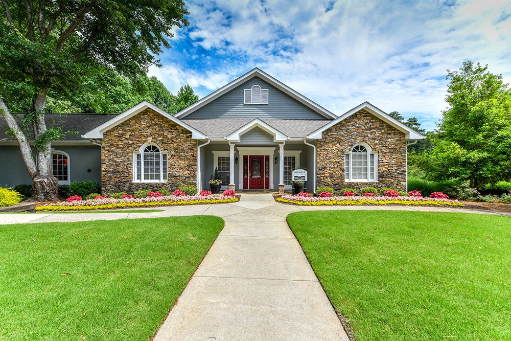 the front of a house with a yard and a walkway