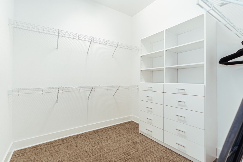 a walk in closet with white closets and shelves and at 20 Midtown, Birmingham, Alabama