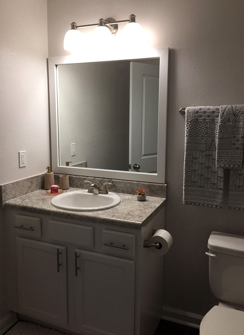 a small bathroom with a sink and a mirror