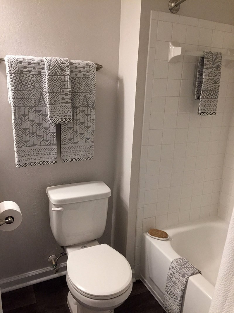 a small bathroom with a toilet and a bath tub