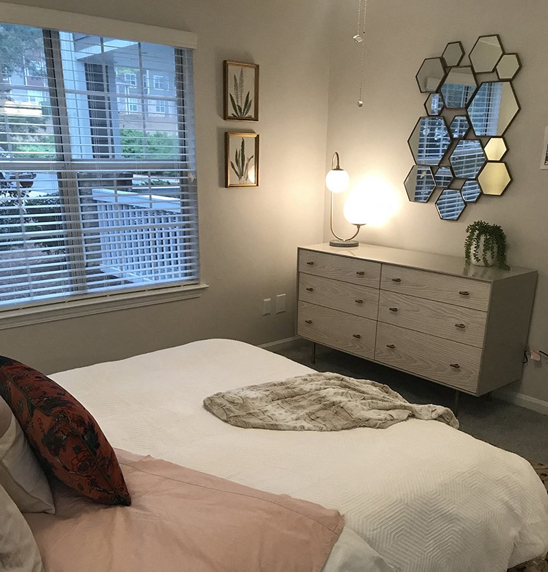 a bedroom with a bed and a dresser