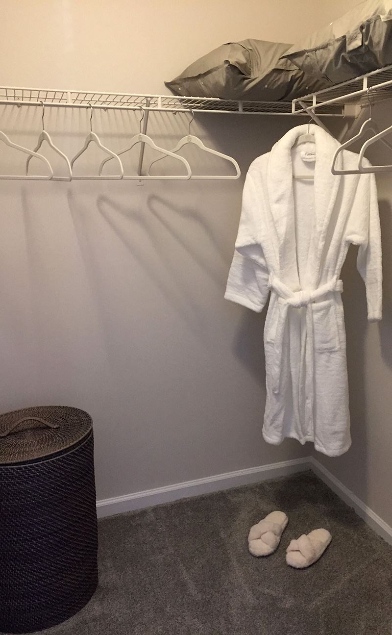 a white robe and white shoes in a closet