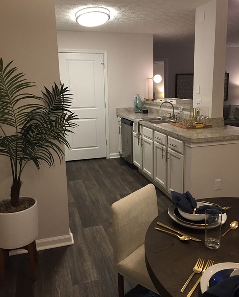 a kitchen and dining room with a sink and a table