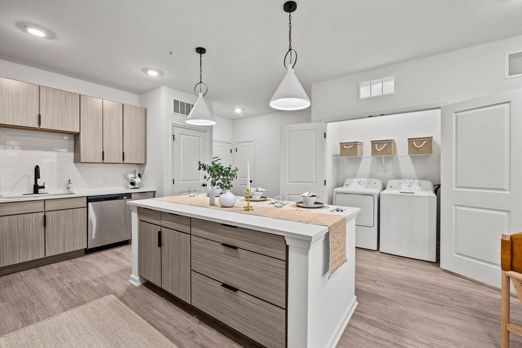 A modern kitchen with wooden cabinets and a white island.