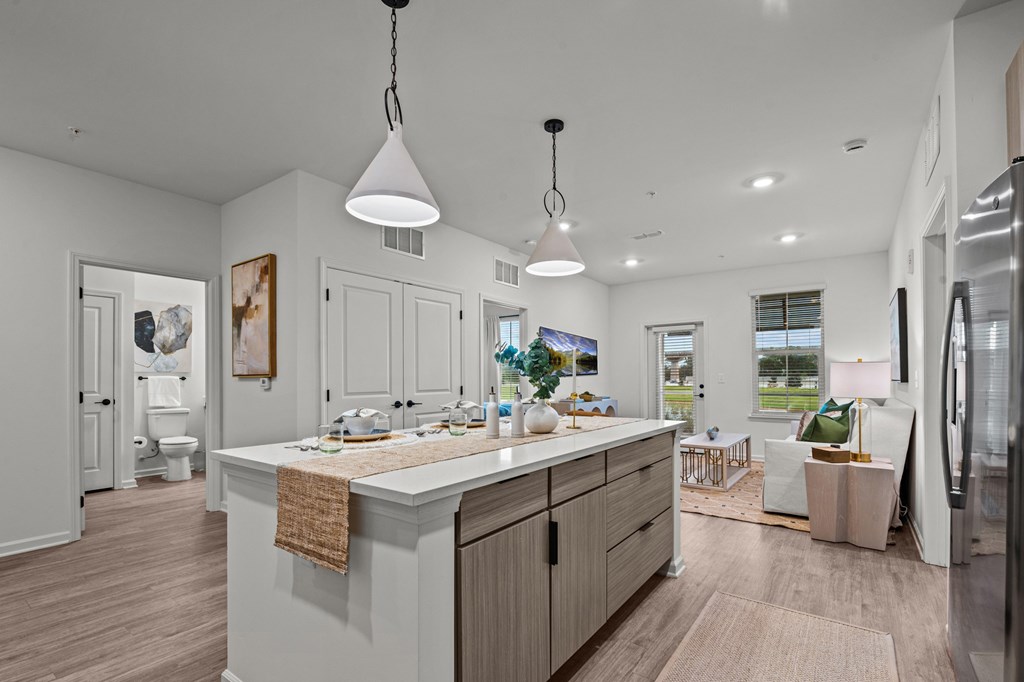 A kitchen with white cabinets and a wooden countertop.