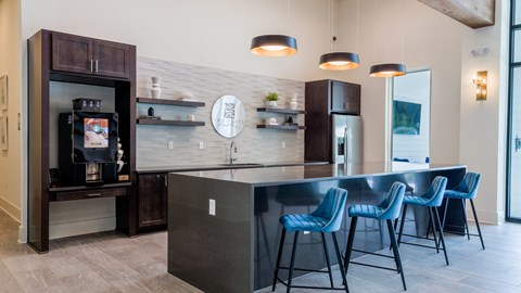 A modern kitchen with dark wood cabinets and a black refrigerator.