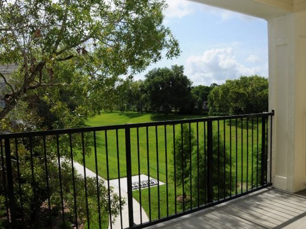 a view of the golf course from the balcony of a house
