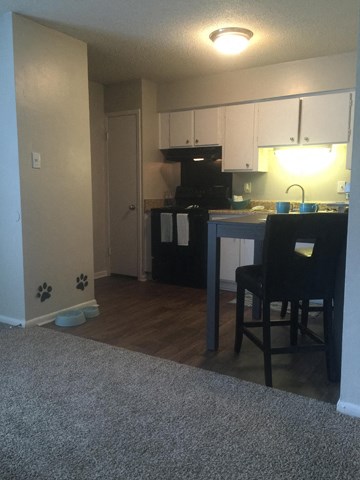 an open kitchen and living room with a table and chairs