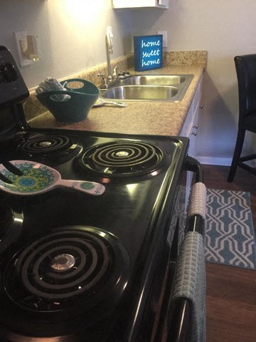 a kitchen with a stove and a sink