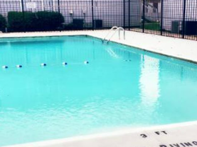 a large swimming pool with a fence around it