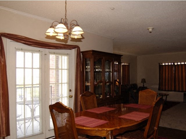 a dining room with a wooden table and chairs