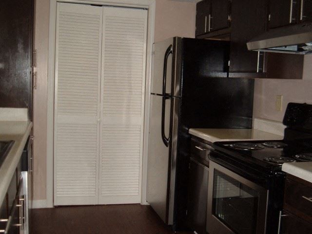 a kitchen with a stove and a refrigerator