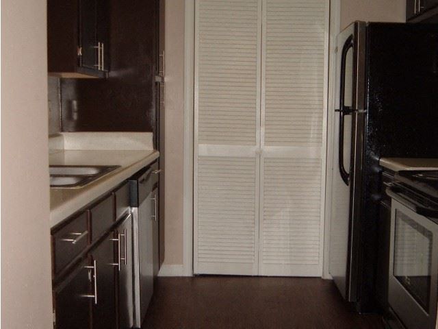 a kitchen with a refrigerator and a sink
