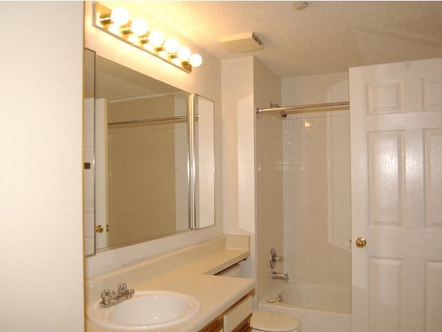 a bathroom with a sink and a mirror and a shower