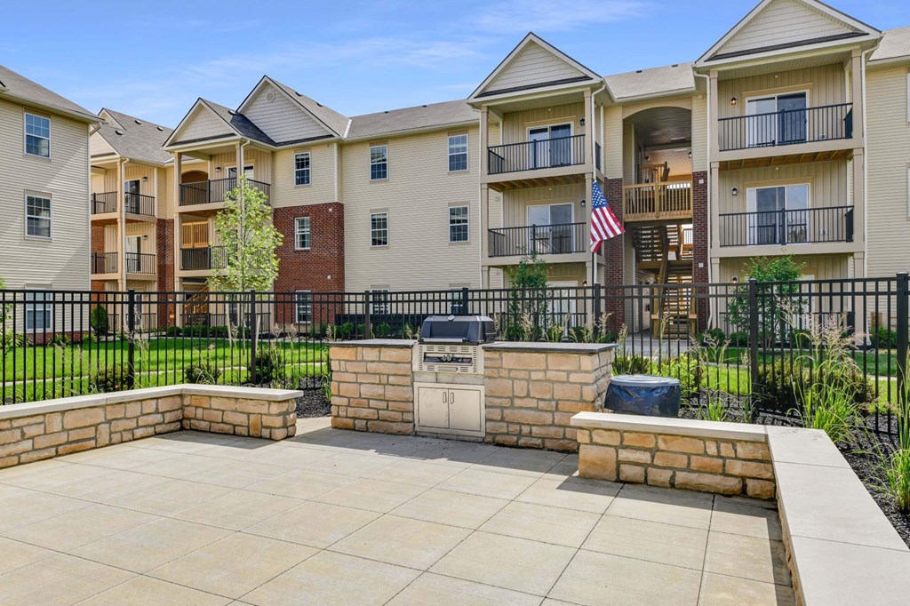 our apartments have a patio with a grill and an flag