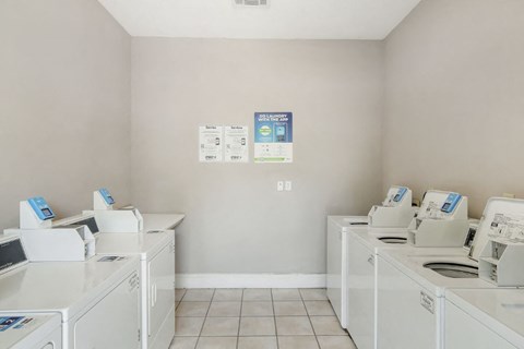a laundry room with washers and dryers
