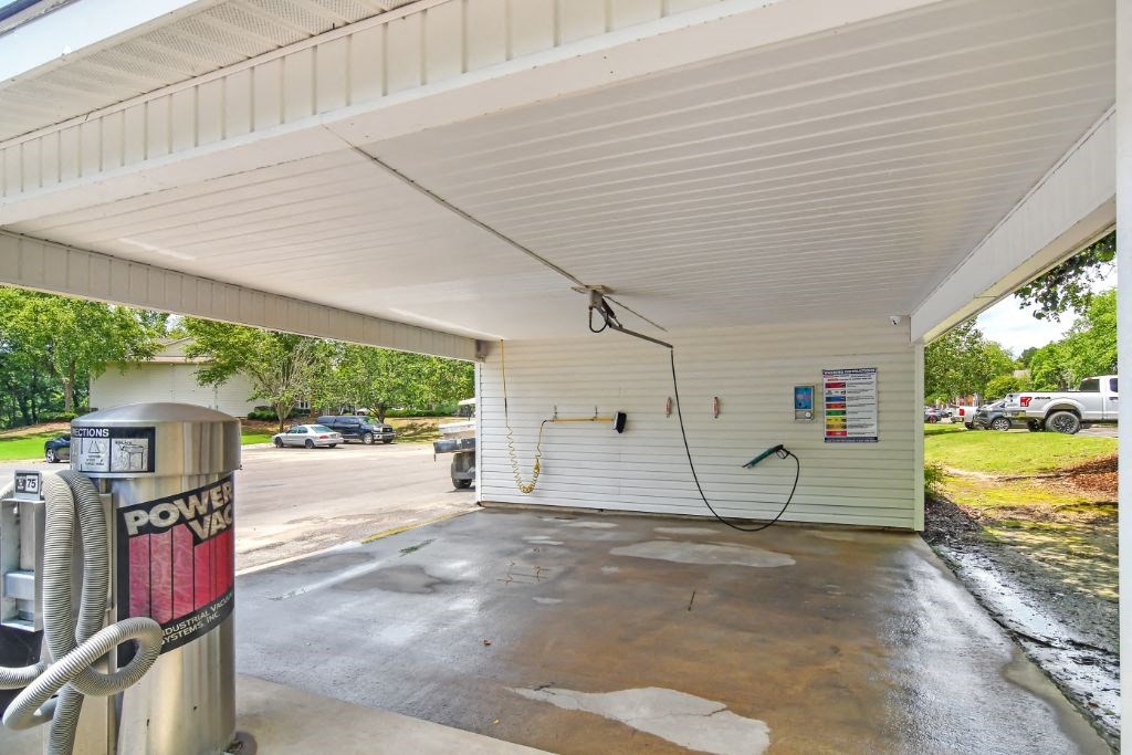 a gas pump in a parking lot with a car in the background