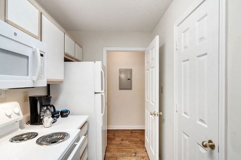 a kitchen with a white stove top oven next to a white refrigerator
