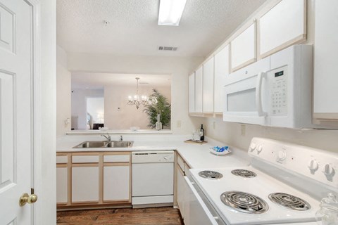 a kitchen with a stove top oven next to a sink