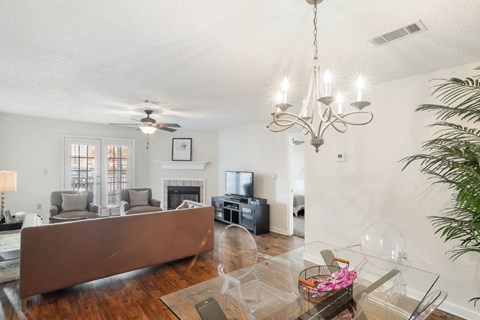 a living room with a fireplace and a glass table