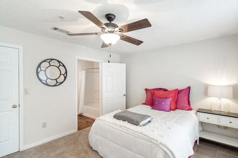 a bedroom with a bed and a ceiling fan