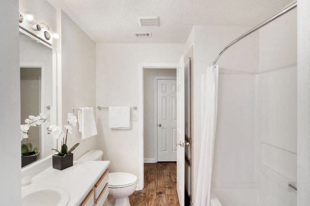 a bathroom with a toilet sink and shower