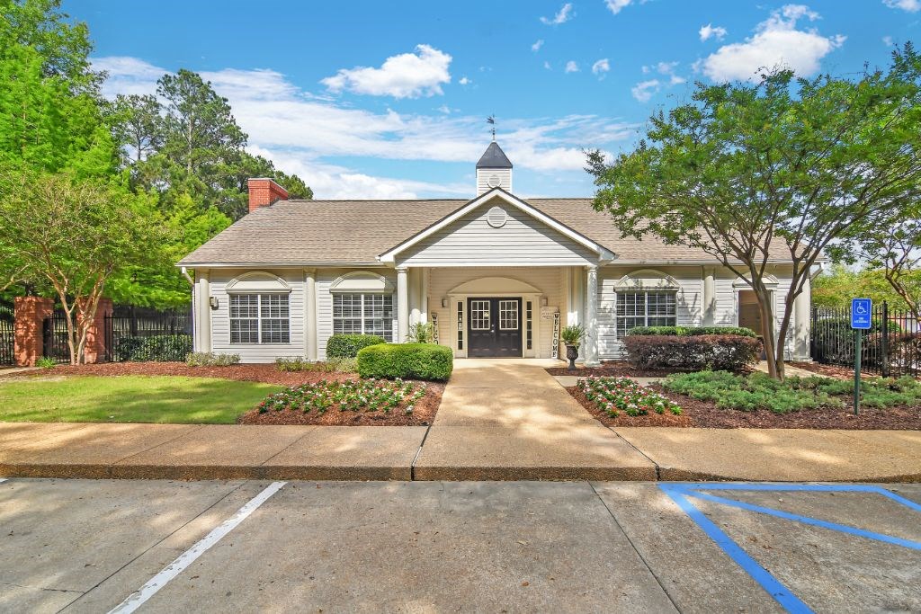 a house with a driveway and a parking lot in front of it