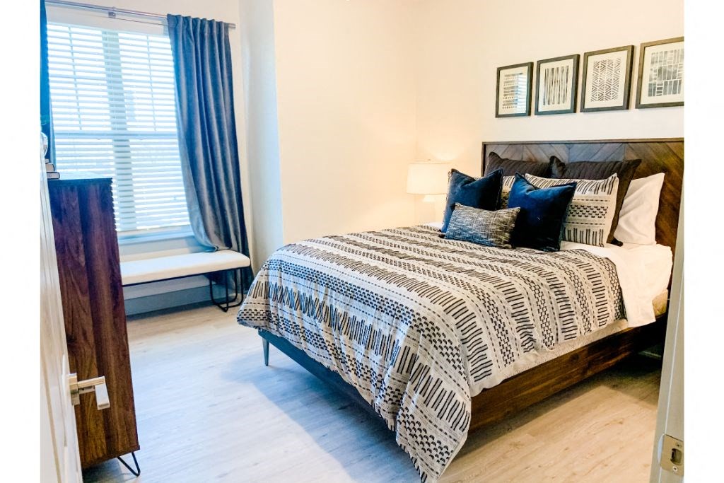 a bedroom with a bed and a window