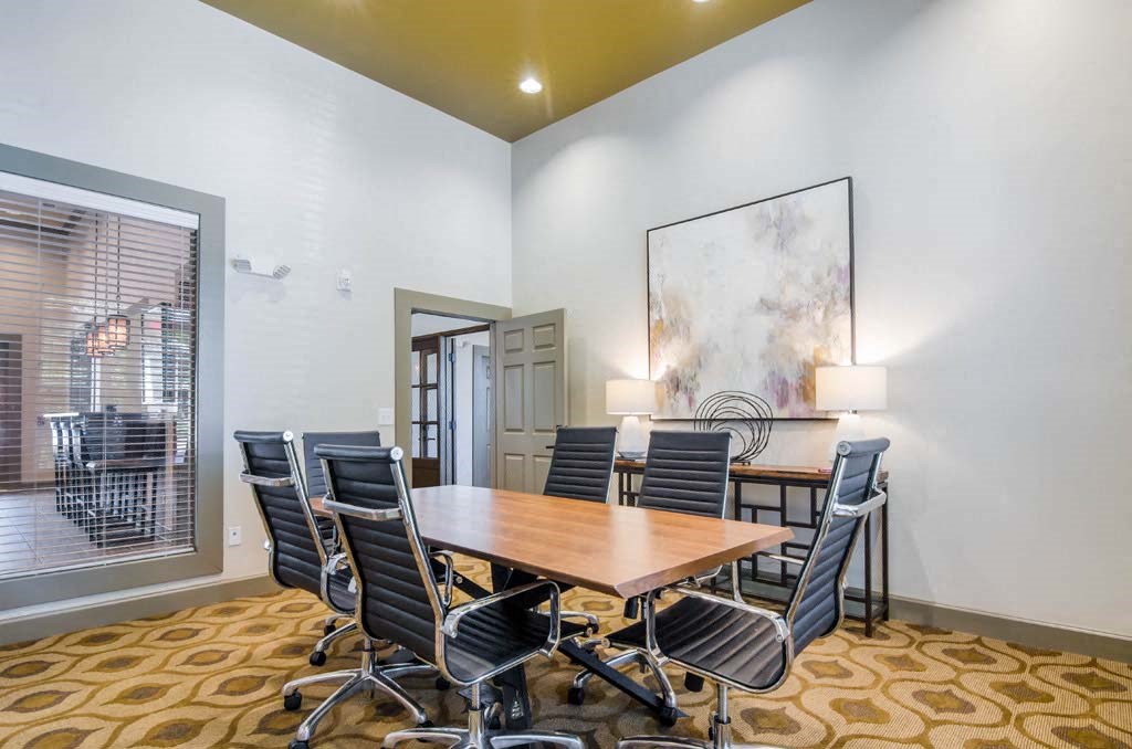 a conference room with a table and chairs