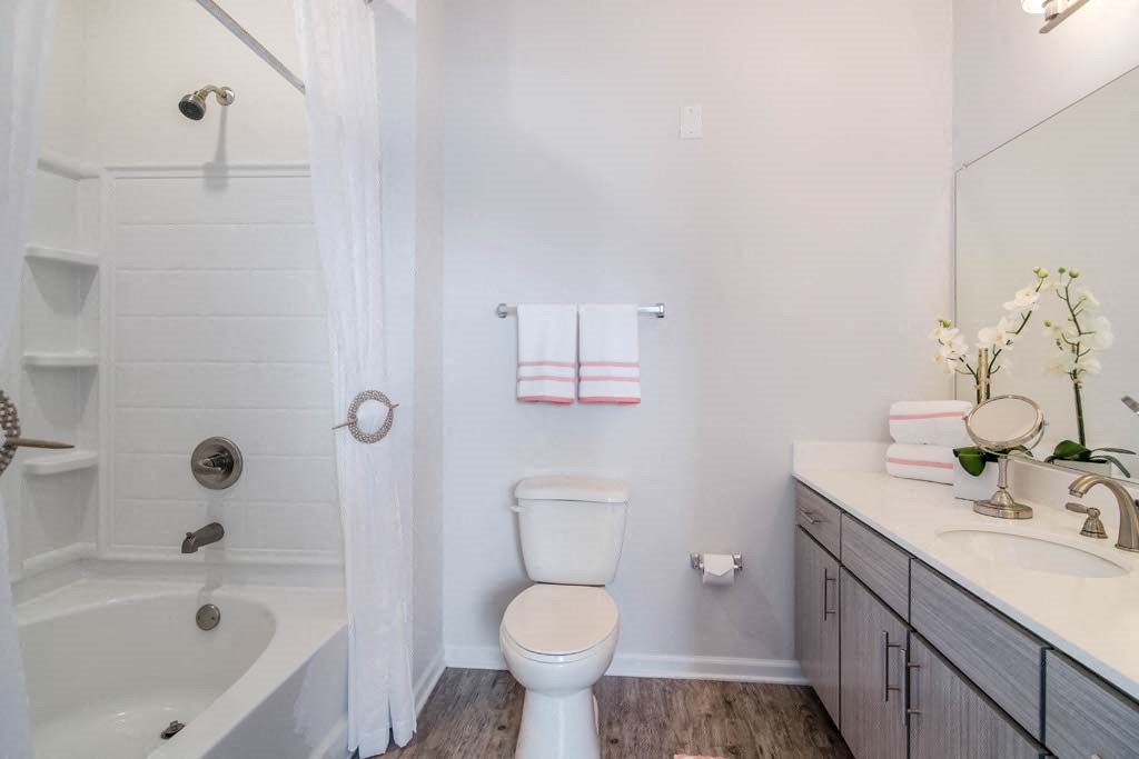a bathroom with a toilet next to a bathtub