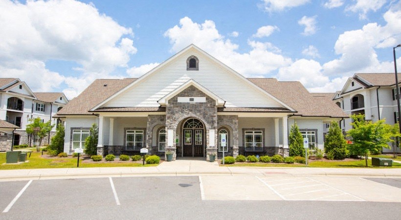 a large building with a driveway in front of it