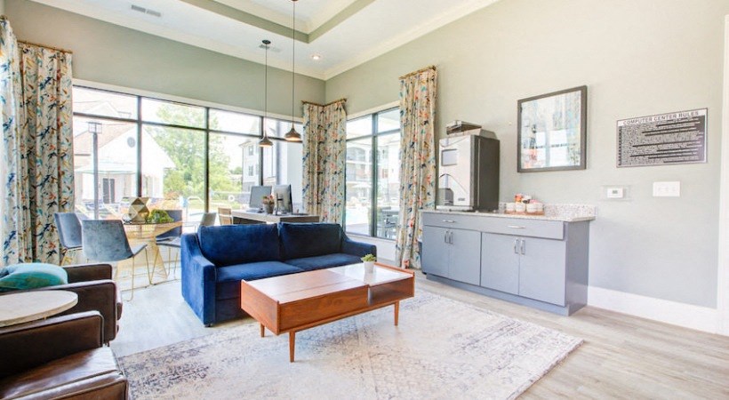 a living room with a blue couch and a coffee table