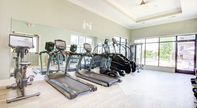 an image of a gym with cardio equipment on the floor