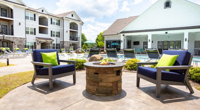 the preserve at ballantyne commons clubhouse with patio furniture and fire pit