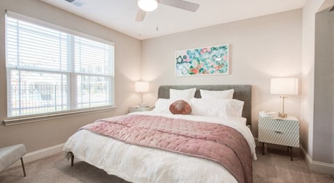 a bedroom with a bed and two windows