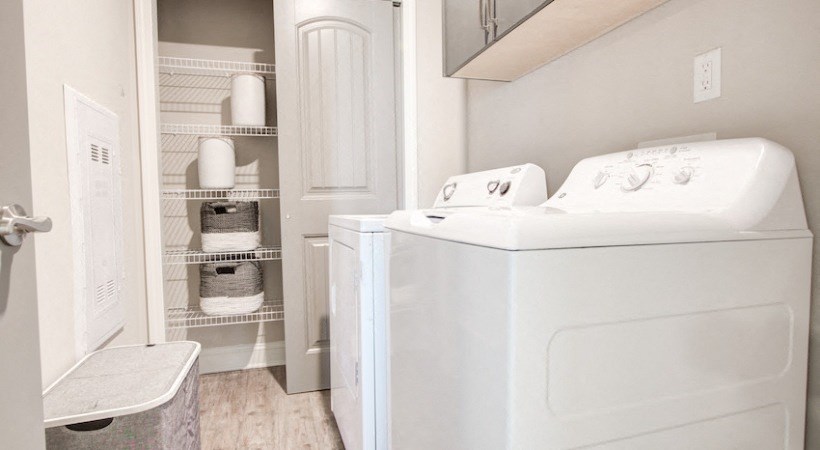 a laundry room with a washer and dryer and a closet