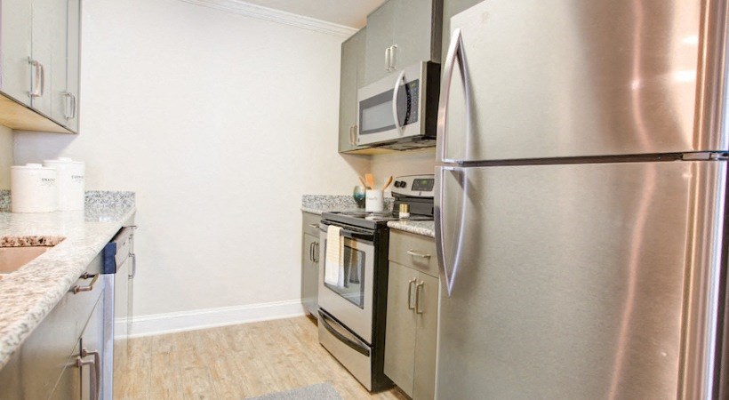 a kitchen with stainless steel appliances and a refrigerator