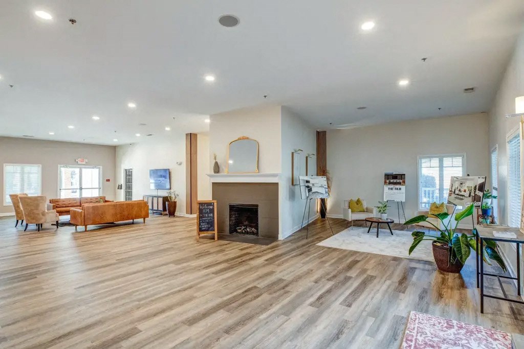 the living room has a fireplace and wood flooring