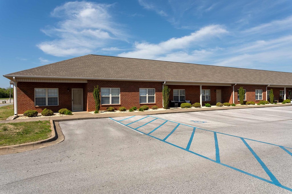 A building with a parking lot in front of it.