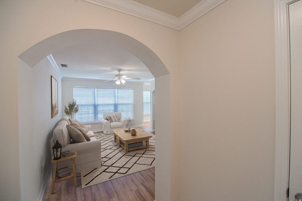 a living room with a couch and a table at 10X Audubon Park apartments in Daphne, AL 