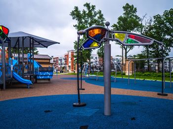 a playground with a swing set and other playground equipment